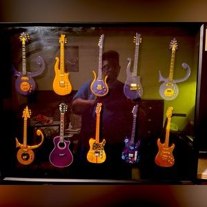 Shadow box featuring various Prince miniature guitars